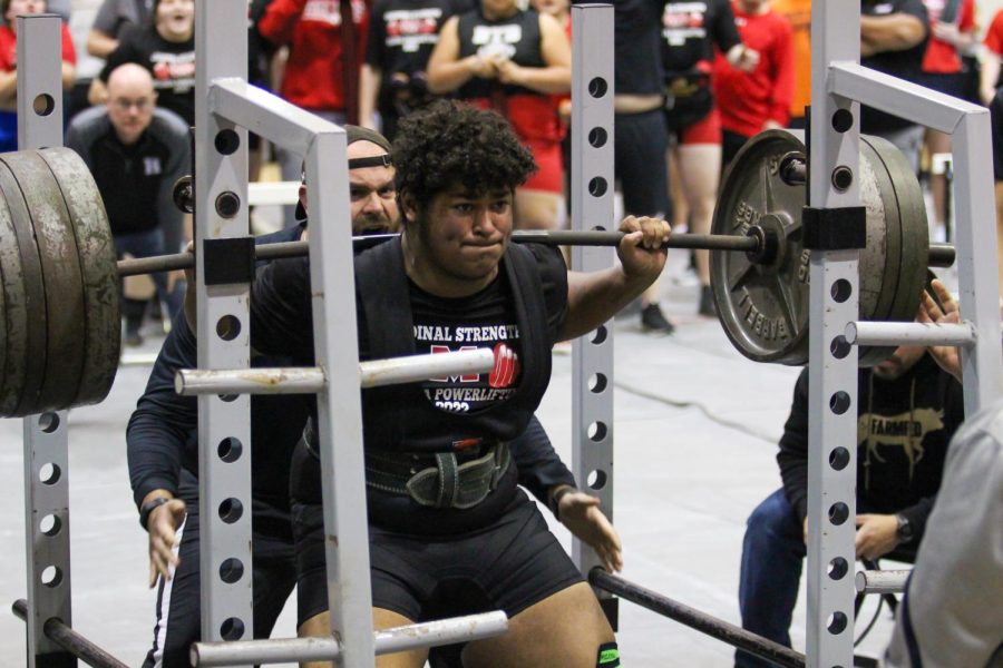 Junior Brandon Ward squats 750 lbs at the Howe Invitational Powerlifting Meet on Feb. 19. Brandon won first place in his weight class and Melissa won the meet overall.