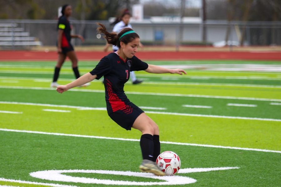 Junior Emely Aguilar moves the ball down the field. The Lady Cards, who are currently in 2nd place in district, defeated Farmersville, 12-0, at home on March 5.