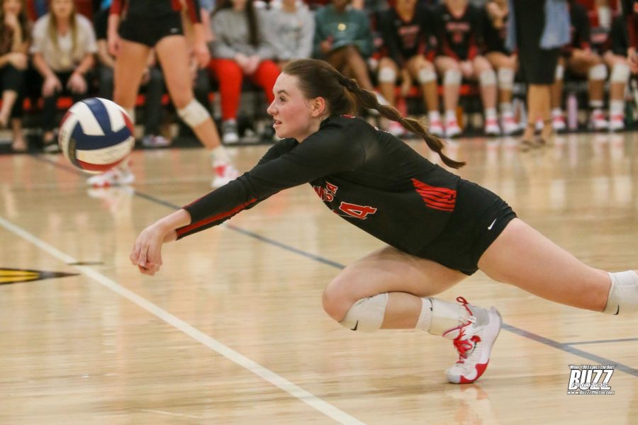 Senior Kenzie Segleski (14) digs deep during one of varsitys games against Greenville on Sept. 16. The Lady Cards won all three matches and are currently in third place in district.