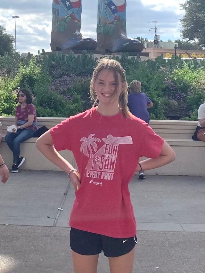Freshman Ashley Swezey stands in front of Big Tex while visiting the State Fair of Texas.