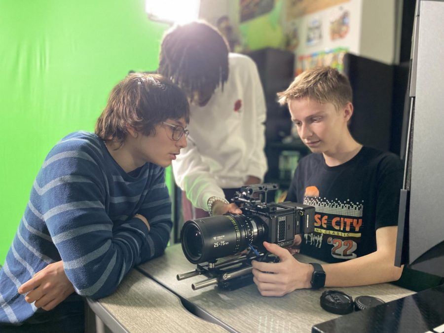 Students work with professional video cameras in AV Production classes.