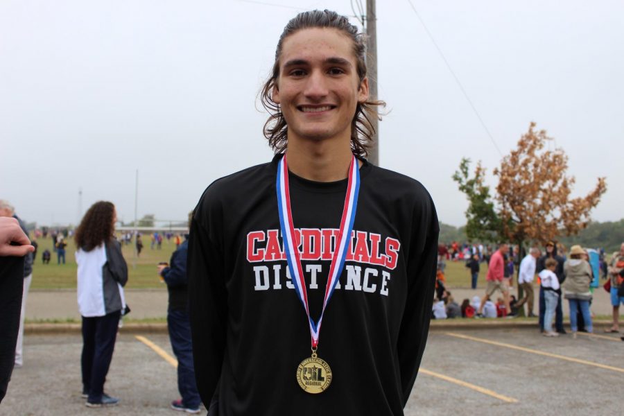 Junior+Judson+Greer+shows+off+his+first+place+medal%2C+which+qualifies+him+for+the+state+meet.