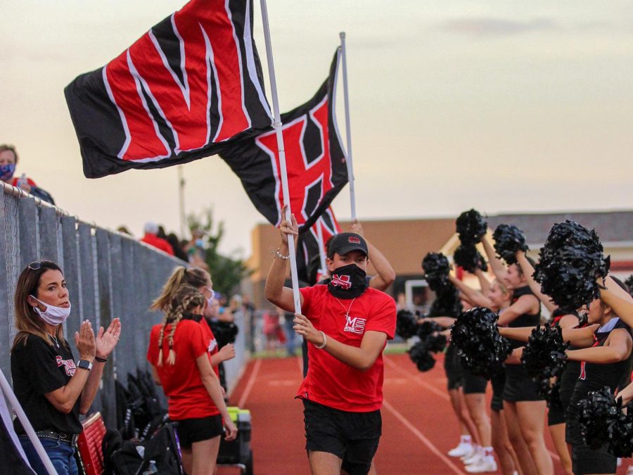 The flag runners display school pride for one of the many Cardinal touchdowns in their victory over Sunnyvale.