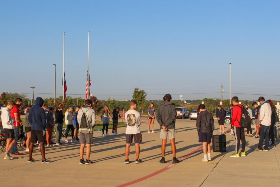 With flags flying half-mast to honor the passing of Chief Justice Ginsburg, students and faculty members gather early on Fri., Sept. 25, for fellowship and prayer. This annual event is sponsored by Fellowship of Christian Athletes (FCA).