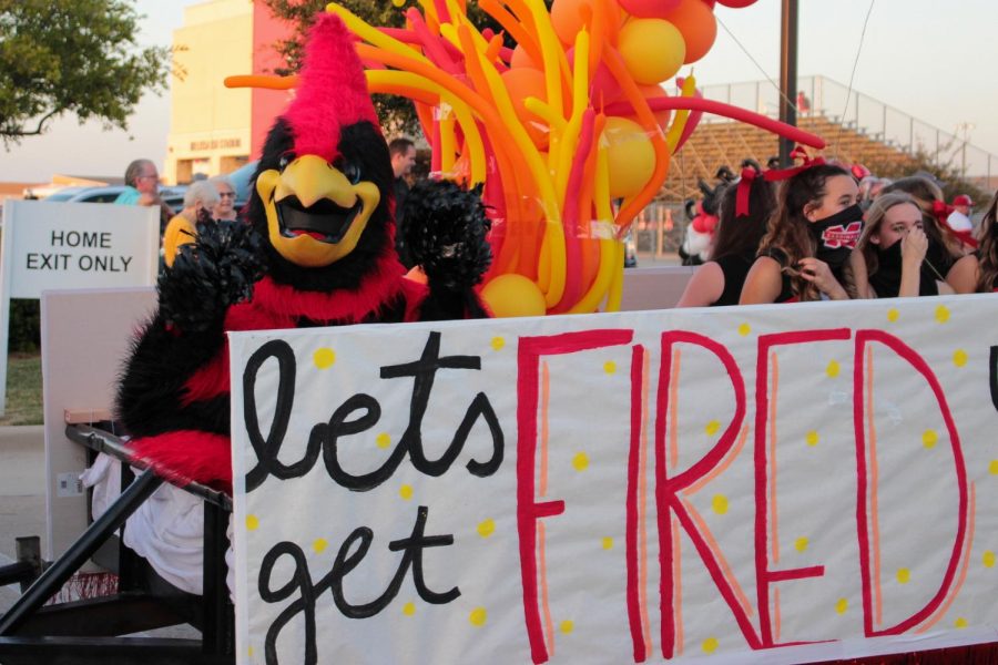 Birdie rides on the varsity cheer float in the homecoming parade in 2020.