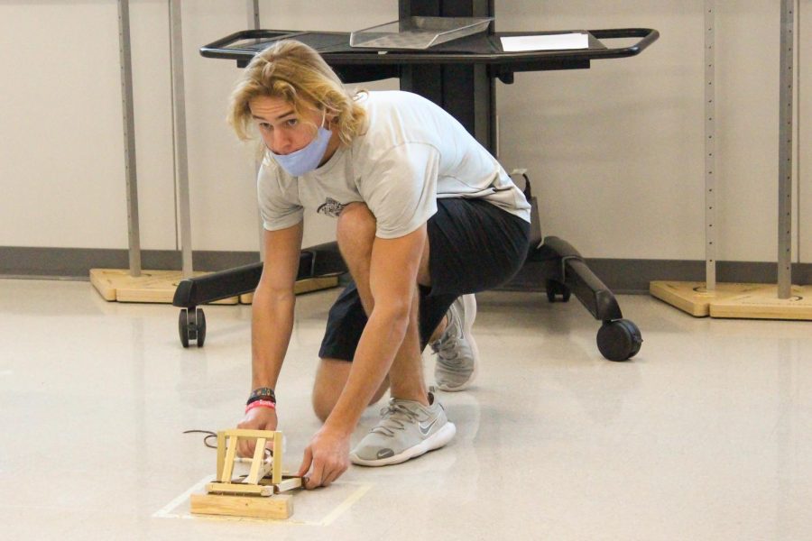 Junior Cord Cruce prepares to test his catapult in honors physics class.
