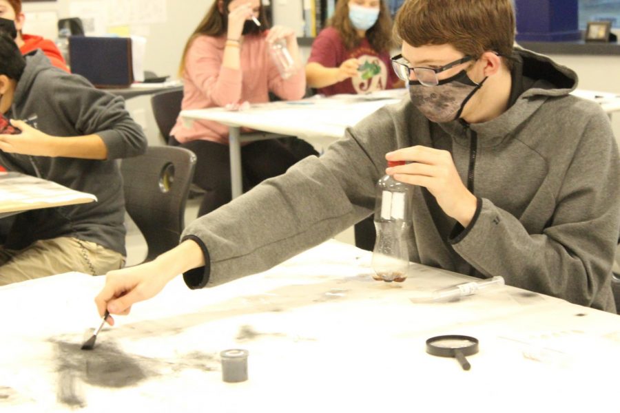 Students learn to dust for fingerprints in Officer Hagoods law enforcement classes.