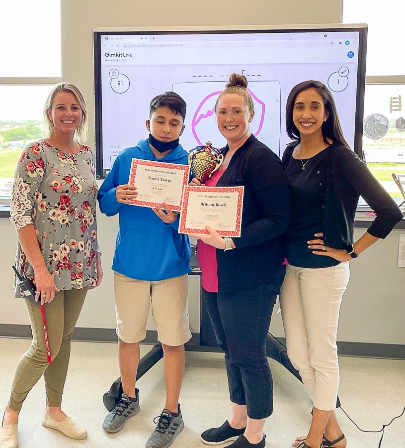 Assistant Principal Stacy Needham presents the Cardinals of the Week Awards to Daniel Torres and Brittany Rosch. Also pictured is Christina Pinckney, last weeks teacher, who passed the trophy to Mrs. Rosch.