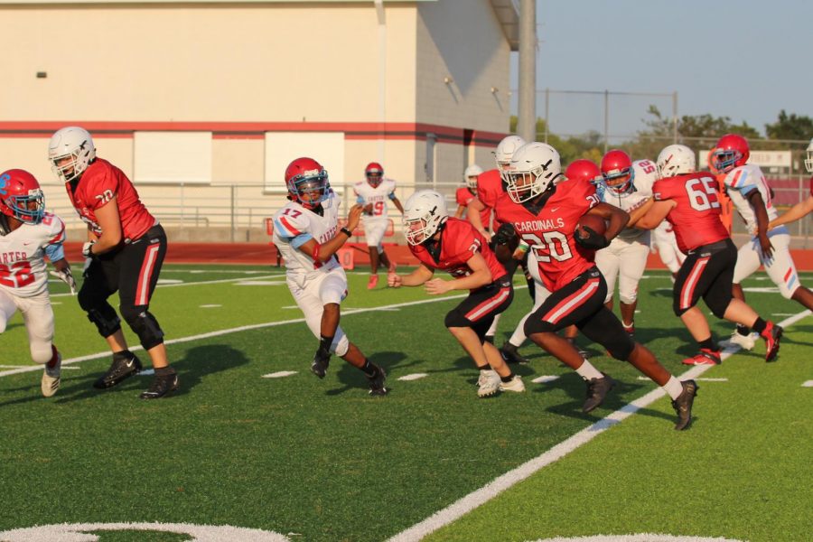 Running for yet another Cardinal touchdown, sophomore Bishop Curry (#20) carries the ball toward the end zone. The JV team defeated Dallas Carter 42-0 at Cardinal Stadium on Sept. 9.