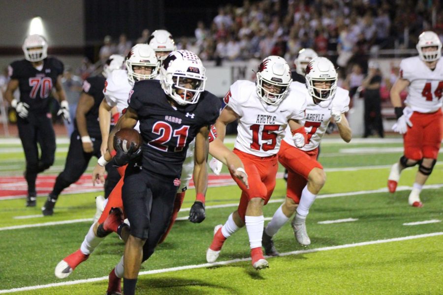 Sophomore Nate Adejokun (21) runs the ball down the field during last Fridays district game against Argyle. The Cardinals shut out the Eagles, 21-0.
