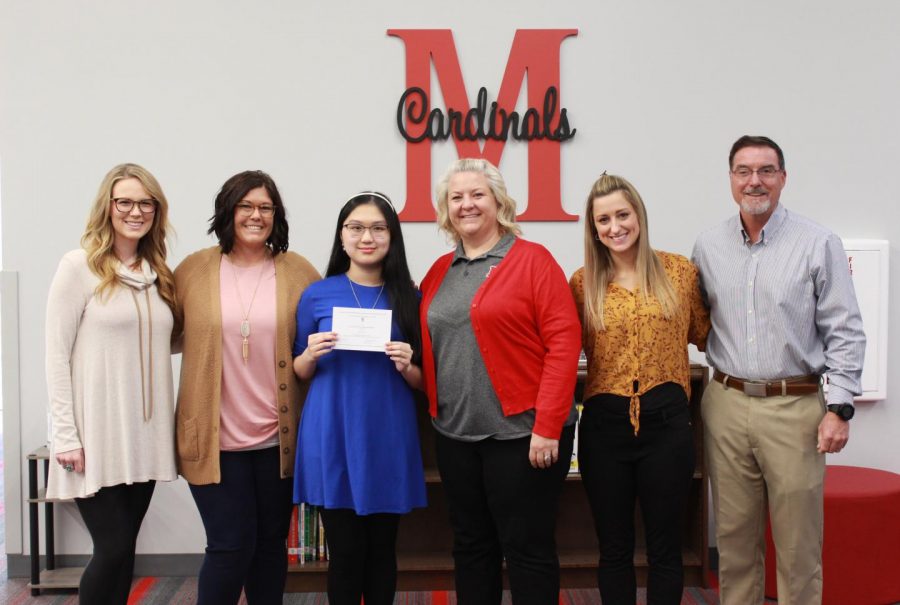 Senior Chau Hua poses with her National Merit Scholarship award and the counselors and principals.