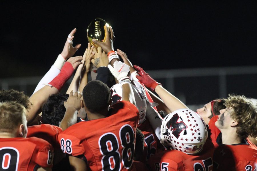 The Cardinals clench their bi-district trophy after their victory over North Dallas, 73-20.