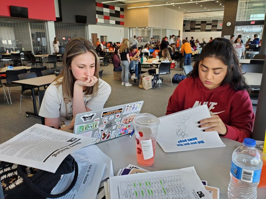Juniors Abigail Chaloupka and Rozleyn Brown practice for UIL News Writing.