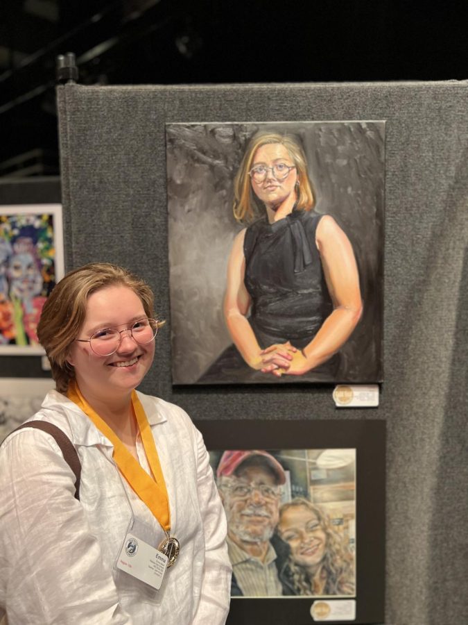 Senior Emma Bean  receives a Gold Seal for her self-portrait.