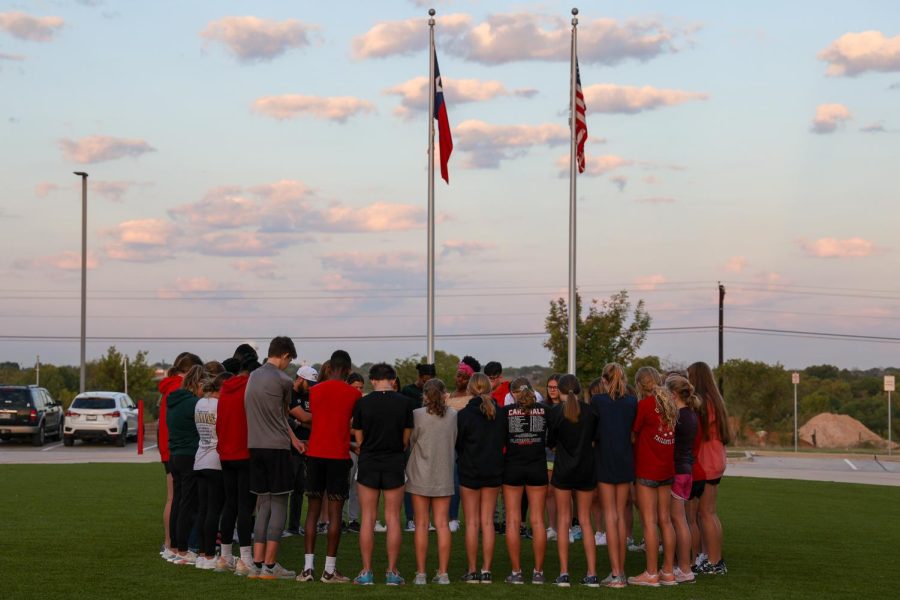 Students and faculty members gather and pray at the annual See You at the Pole event sponsored by FCA on Sept. 28.
