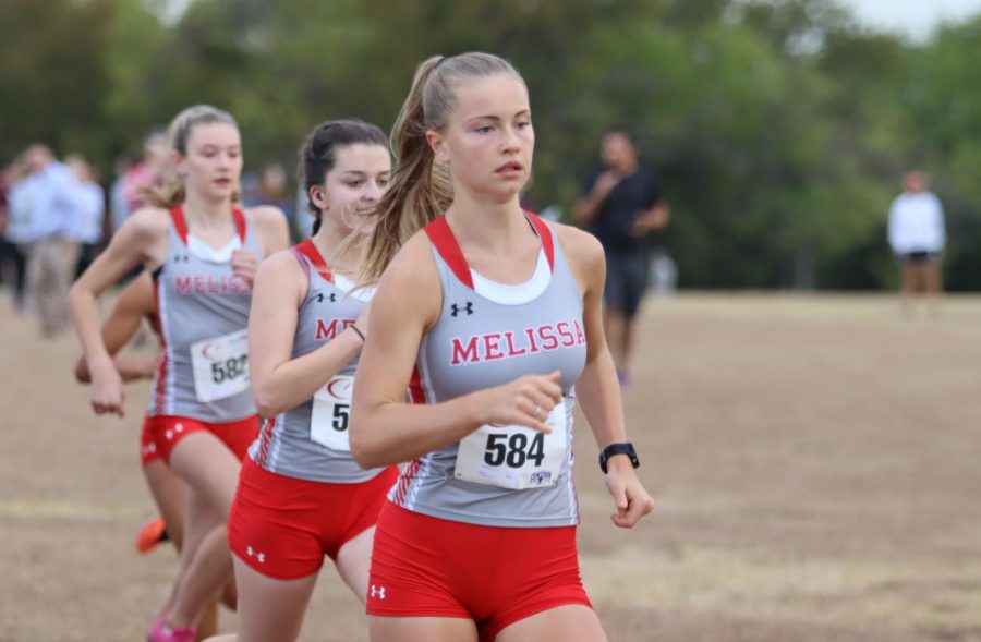 Leading+the+varsity+girls+team%2C+senior+Abi+Bass+sets+the+pace+early+at+the+5A+District+13+Cross+Country+Meet+held+at+Myers+Park+in+McKinney+on+Oct.+11.+Bass+finished+in+2nd+place+individually%2C+and+both+the+varsity+girls+and+boys+teams+finished+in+3rd+place%2C+advancing+to+the+regional+meet.