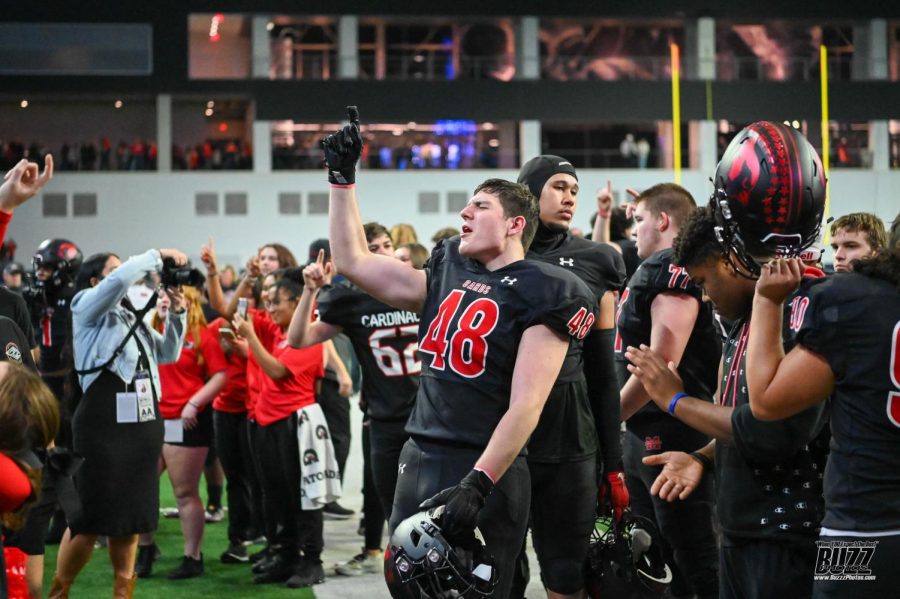 Senior Lance Riley sings the school song to celebrate their win over Terrell in the regional round of the playoffs held Nov. 25 at The Star in Frisco.