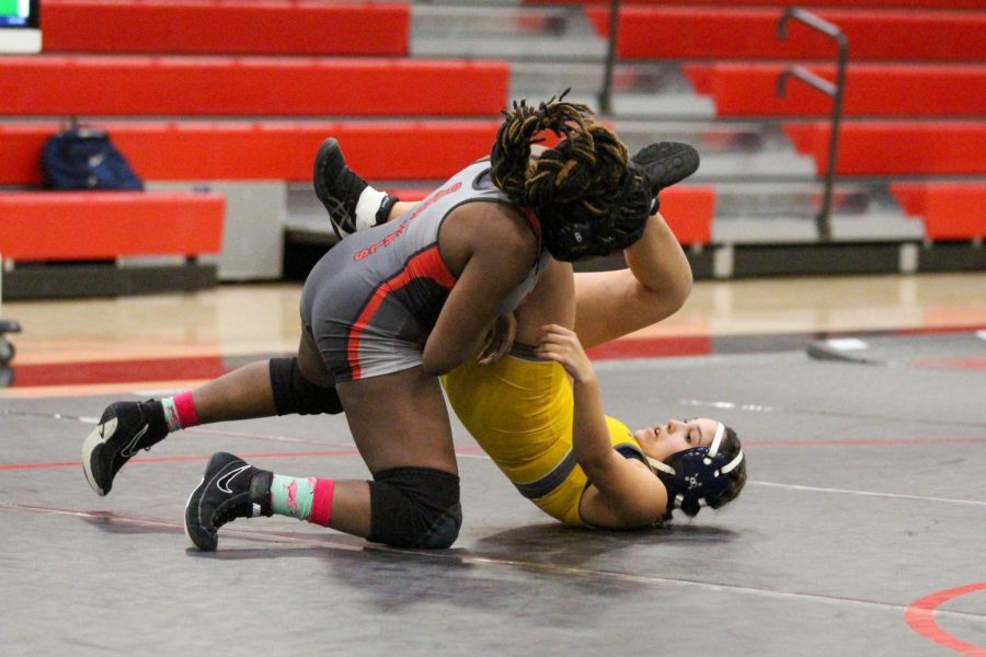 Freshman Kay Ndanzia pins her McKinney opponent at the home duels on Jan. 26. 