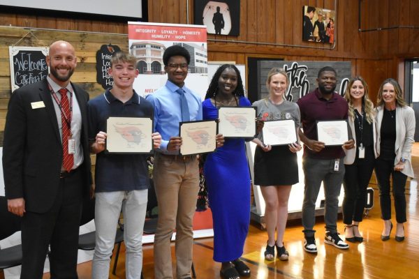 Students and staff members receive Cardinal Commendations at the school board meeting on Sept. 18. Pictured left to right: Marcus Eckert, Hudson Ross, Joshua Ester, Rennice Kerebi, Henslie Fournier, Jamain Williams, Emily Chapman and Amy Feagin.
