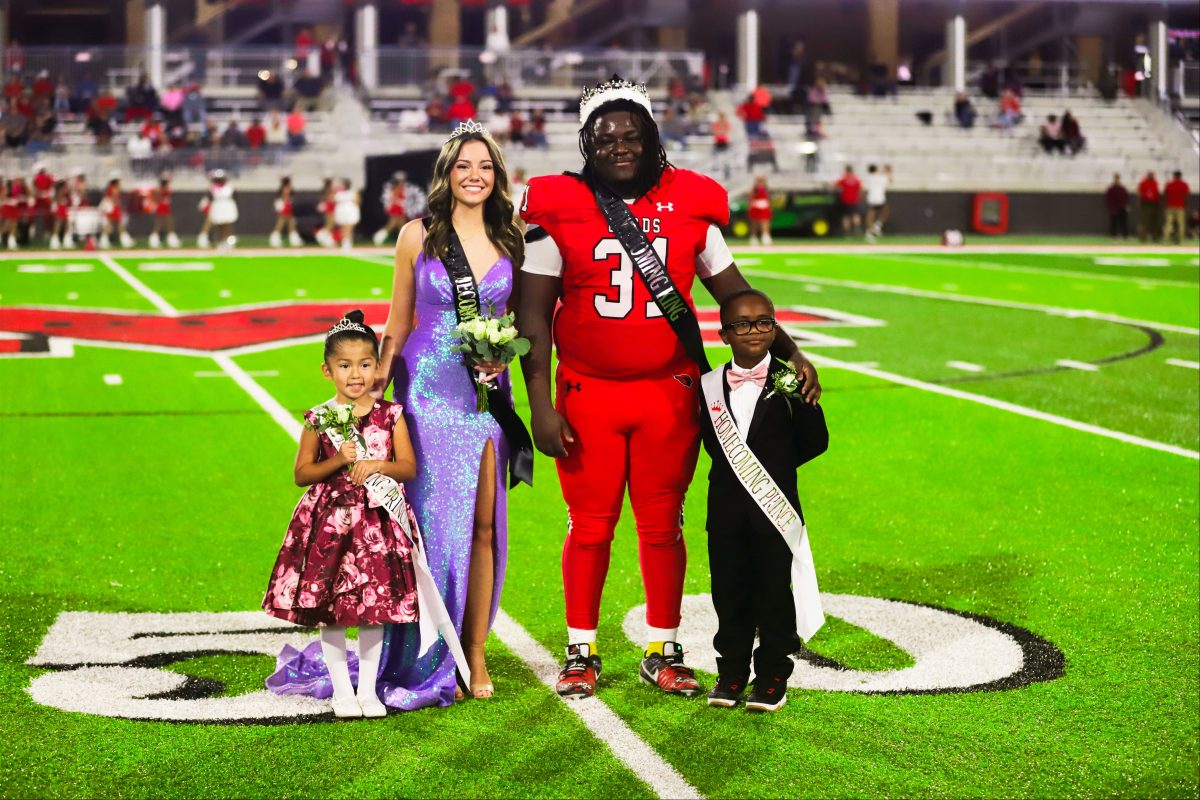 Homecoming King DKedrion Abrams and Queen Josephine Miller are coronated during halftime at the varsity game against Greenville on Oct. 20.  Also pictured are Homecoming Prince and Princess Elijah Njorge and Sofia Arteaga.
