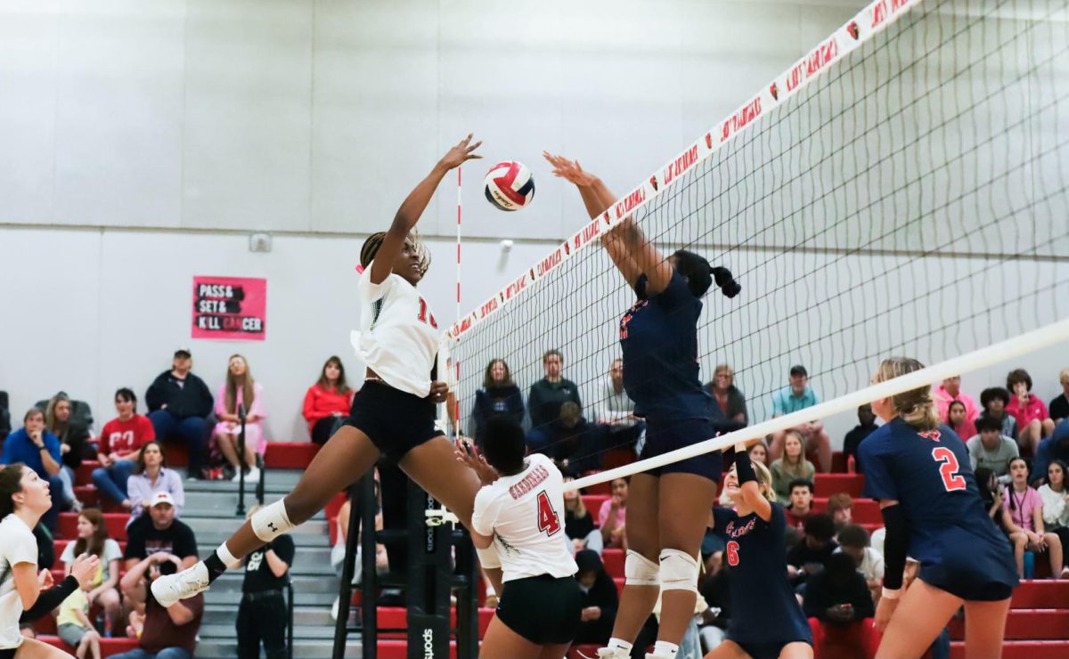 Junior Nena Kpea spikes the ball over the net in the final home game against McKinney North on Oct. 24. The Lady Cards finished in 2nd place in district, won bi-district Oct. 30 and play for area on Nov. 3.