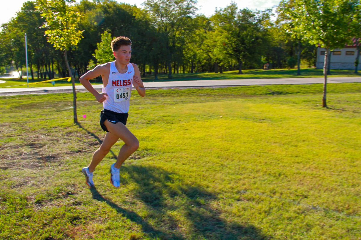 Senior Logan Tauch advances to the finish line at the 13-5A District Cross Country meet held at Myers Park on Oct. 10.