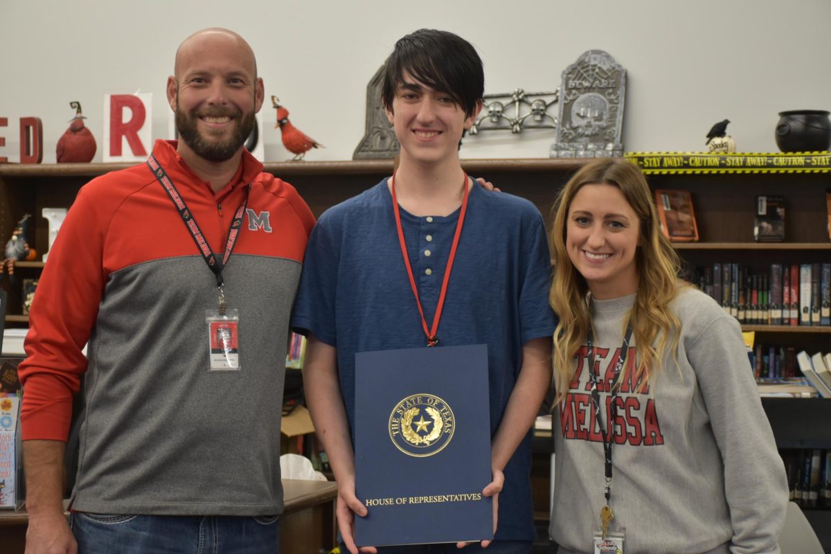 Senior Tyler Mathieson receives recognition from State Representative Frazier. Pictured with Tyler are Principal Marcus Eckert and Associate Principal Emily Chapman.