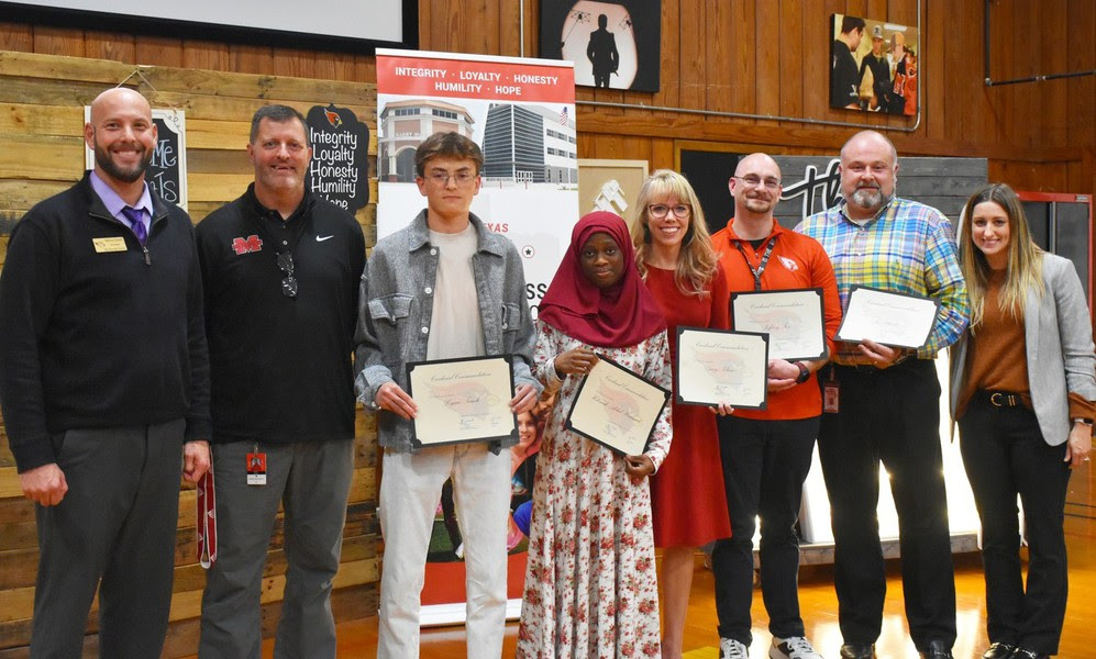 High school students Logan Tauch and Hikmah Abdul-Hammed along with staff members Jon Wheeler, Amy Klein and Jeffrey Fox receive Cardinal Commendations at the November board meeting.