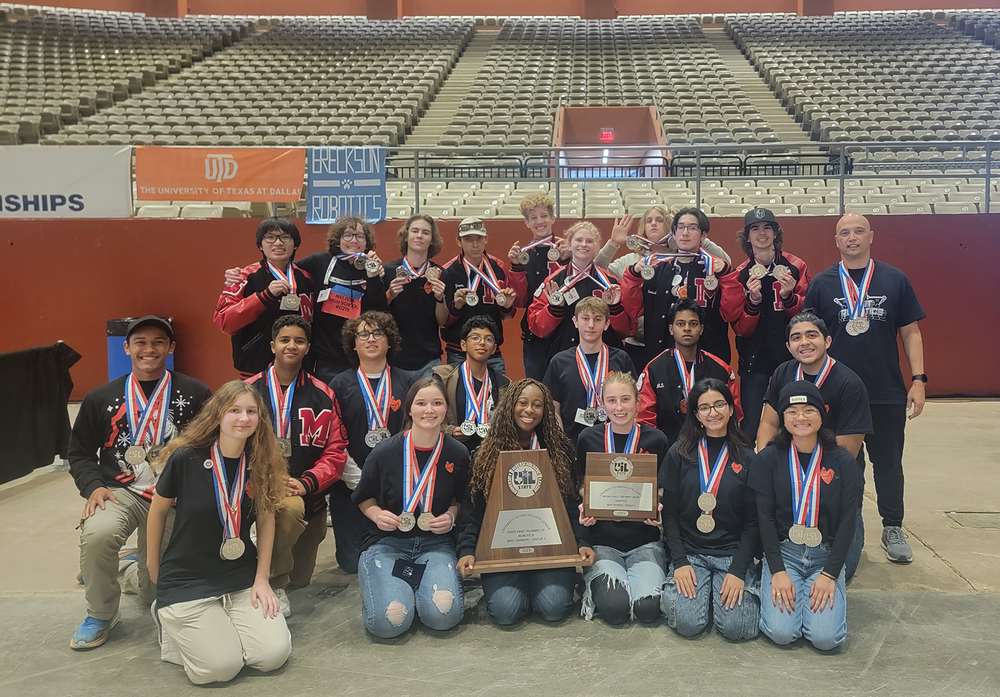 The robotics team poses with their trophies and medals.