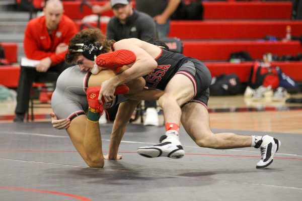 Senior Mercer Ashley dominates his Lovejoy opponent on the mat, 17-3, in a dual on Jan. 18. Overall, the Cardinals defeated the Leopards 55-18.