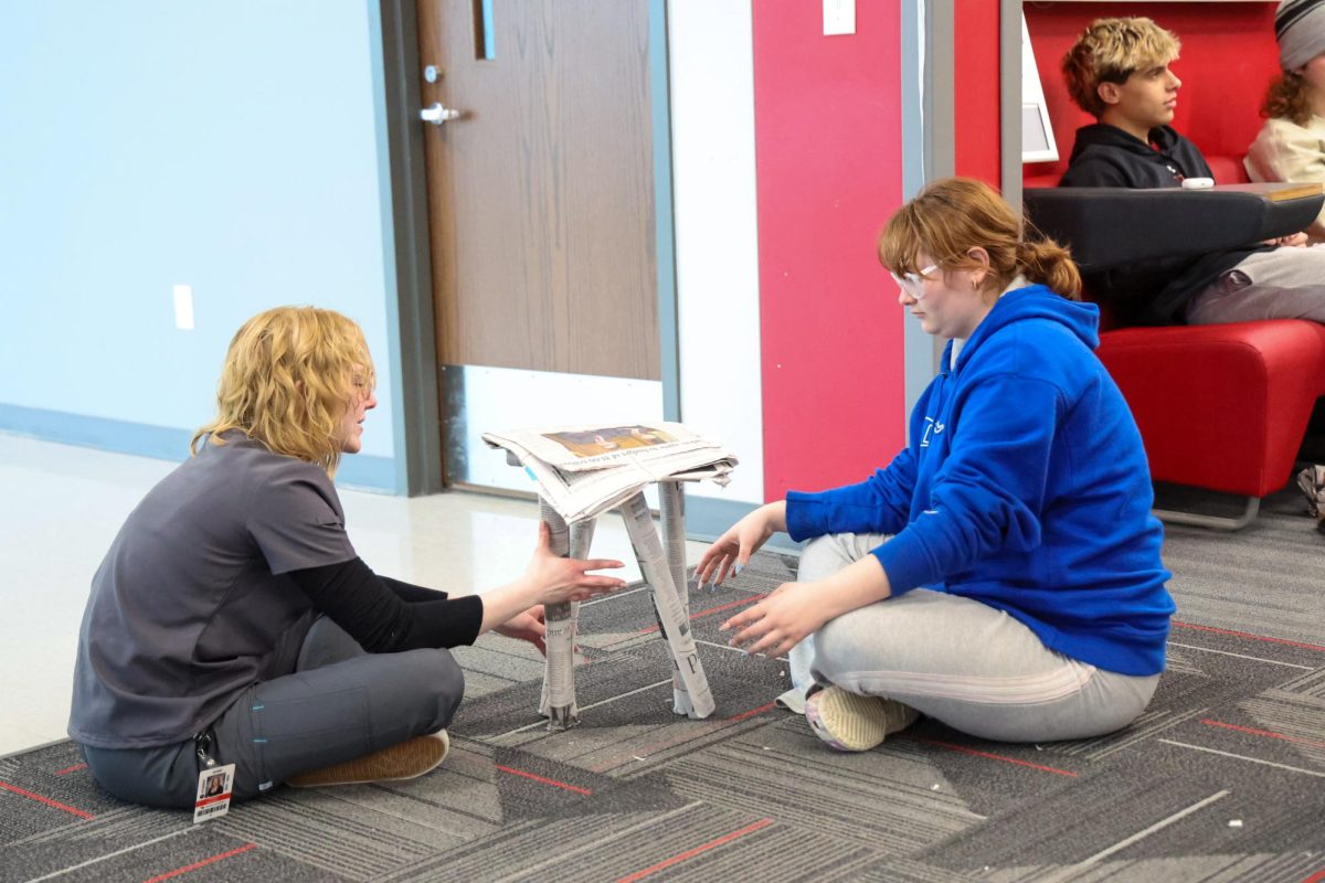 Students in Mrs. Slentzs physics classes build newspaper chairs on Jan. 26. Each group had to test their chair to see if it could hold a person sitting on it for five minutes.