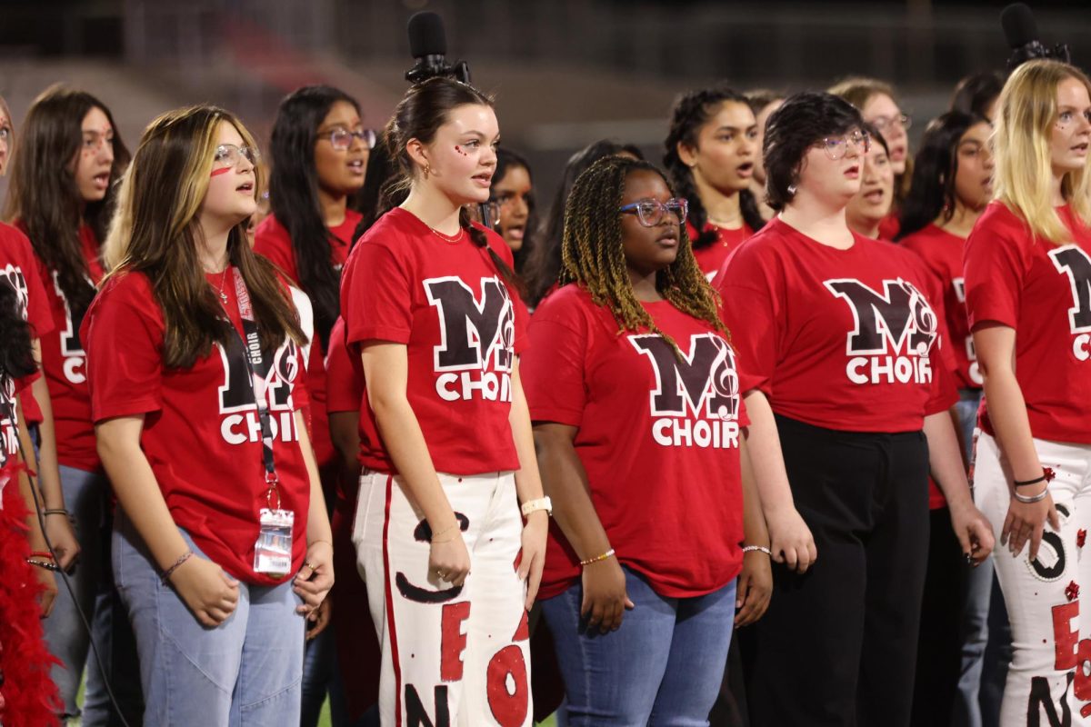 The MHS Choir sings the National Anthem before the homecoming football game on Oct. 20 in Coach Kenny Deel Stadium. 
