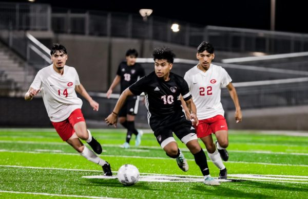 Senior Jordy Vasquez dribbles the ball down the field in the home match against Greenville on Feb. 2.