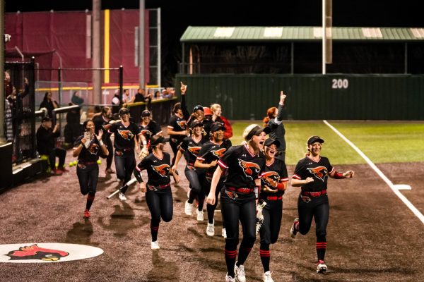 The Lady Cards rally onto the field. The varsity softball team defeated Lovejoy 8-1 in a home game on March 5.  