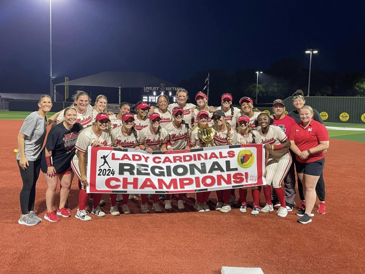 The+Lady+Cards+pose+with+their+regional+championship+banner+after+their+victory+over+Forney+on+May+23+at+Lovejoy+High+School.+They+will+play+in+the+5A+state+semifinals+on+May+31.