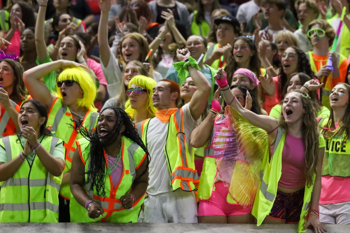 Students dress in neon colors to help the Cardinals "glow" at the Ford Center in The Star at Frisco on Sept. 5. Varsity football defeated Frisco HS, 52-13, in the second game of the season.