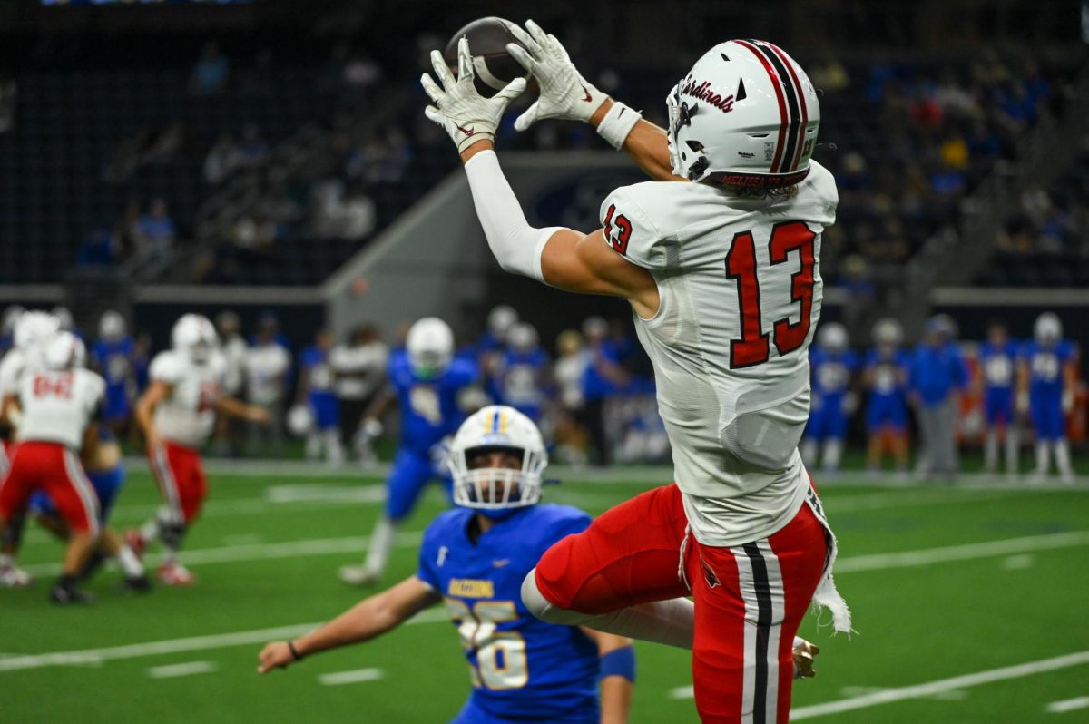 Senior Jacob Nye (13) receives the ball during the game against Frisco on Sept. 5 at the Ford Center. The Cardinals won the game, 50-13.