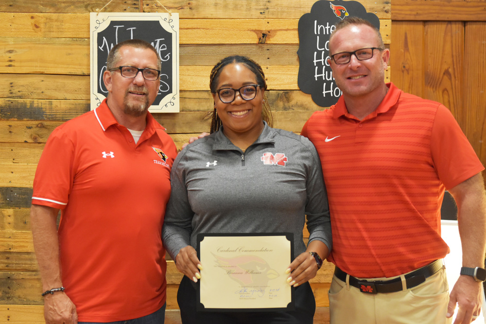 Assistant Athletic Trainer Brianna Williams receives a Cardinal Commendation from the school board.