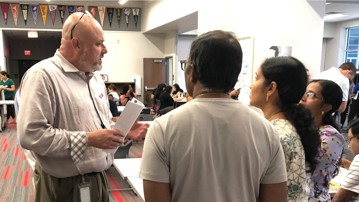 IB Director Jon Wheeler visits with parents about the upcoming implementation of the International Baccalaureate Diploma Programme coming in the Fall of 2025.