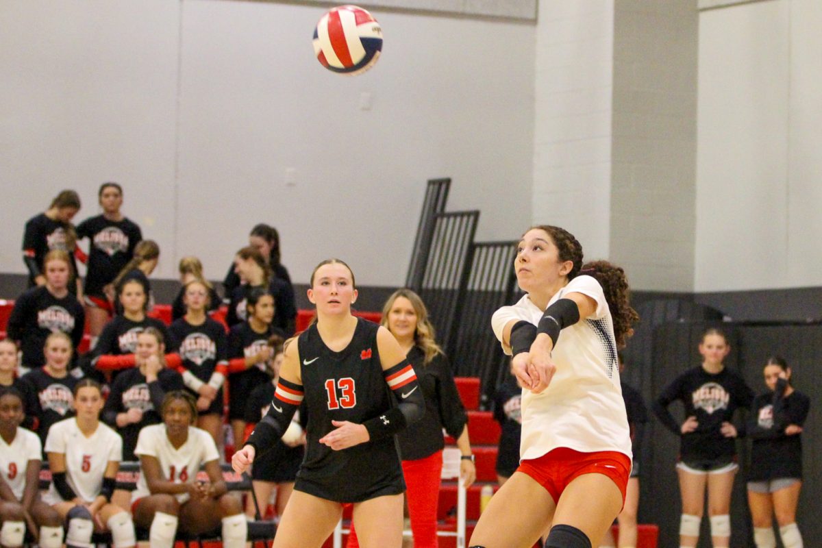 Senior Mackenzi Davis (8) sets the ball for her teammates in one of their matches against Lovejoy on Sept. 27. The Lady Cards, who are currently in 2nd place in district, lost 3-1 to the Lady Leopards, who are currently in 1st place.