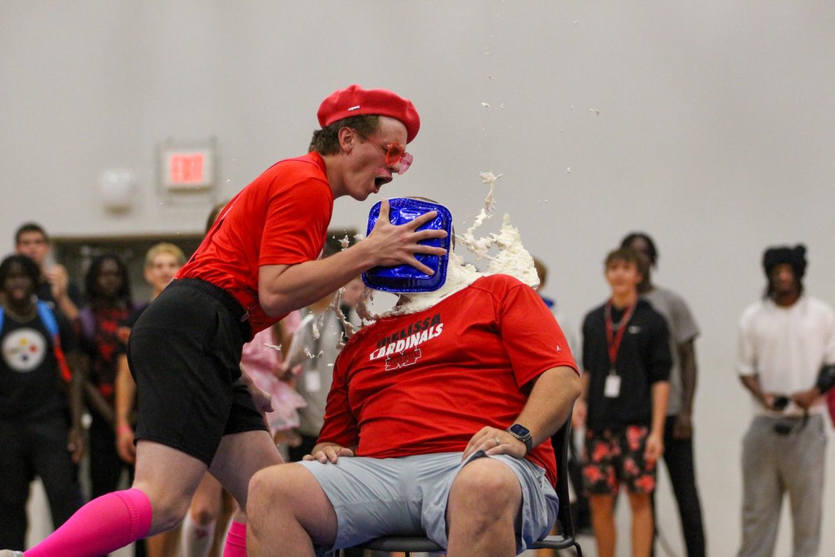 Senior Logan Venner "pies" band director Jerry Whorton during the Pink Out Pep Rally on Oct. 4. Students donated money to raise awareness for breast cancer. Whorton's jug received the most funds making him the winner.