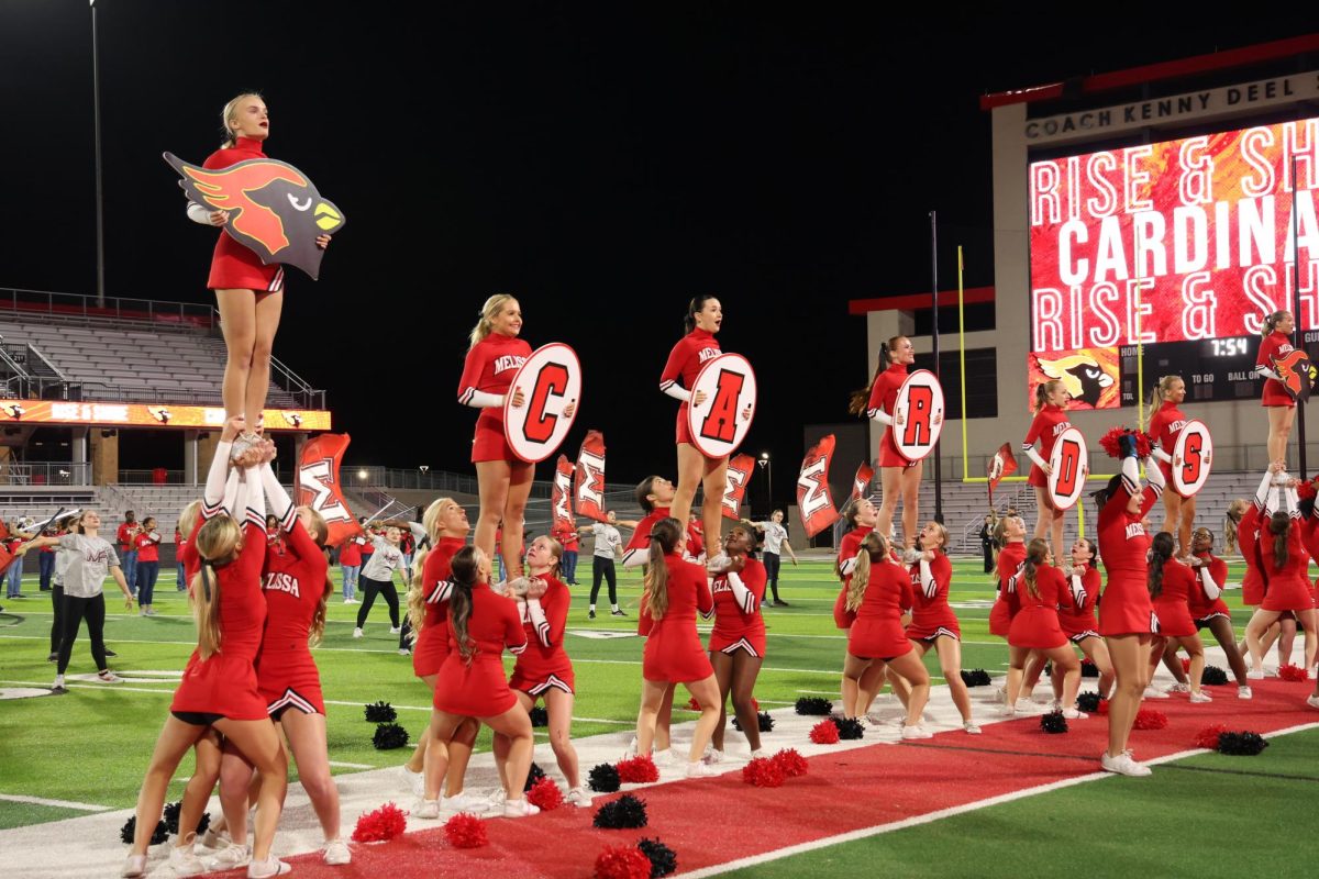 The cheerleaders perform a routine at the community homecoming pep rally on Oct. 16. Cardinal Cheer kicks off their competition season with UCA Regionals on Nov. 10.